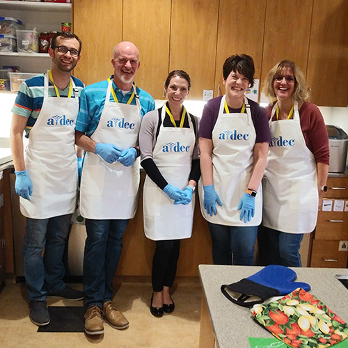 A-dec employees prepare meals for global community service