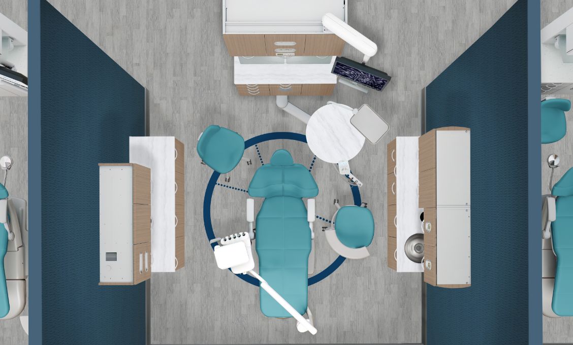 Top down view of a dental operatory with a blue-green chair and dental cabinetry